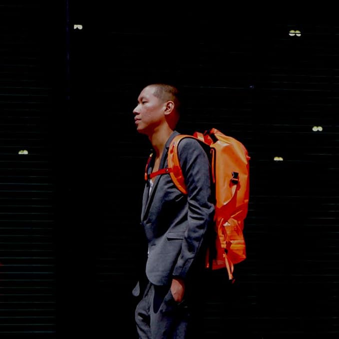 Spin Bag Durable Travel Waterproof Backpack for Men and Women Carry On Bag for Sports Work and Travel with Laptop Sleeve Shoe Compartment and Tactical Features 30 Liter Orange