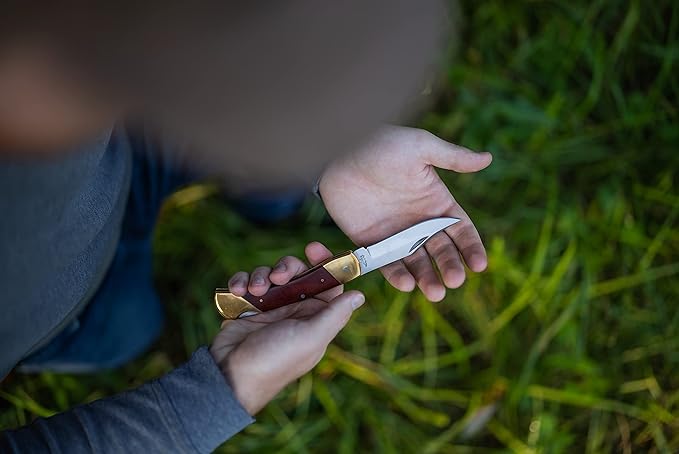 Uncle Henry LB7 Bear Paw Traditional Lockback Pocket Knife with 3.7in Clip Point High Carbon S.S. Blade Wood Handle Brass Bolsters and Leather Belt Sheath for EDC Hunting Camping and Outdoors