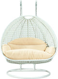 LeisureMod 2 Person Wicker Egg Chair Outdoor Indoor Bedroom Patio Hanging Lounge Swing Hammock Chairs with White Stand and UV Resistant Cushions (Cream)